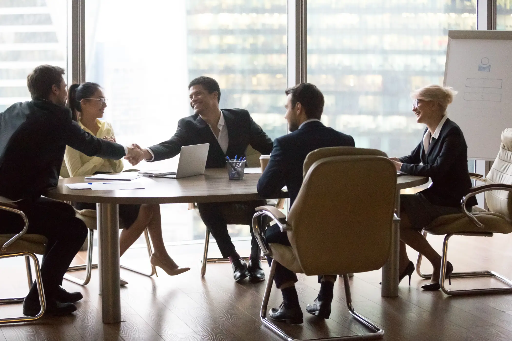business people shaking hands in a conference room